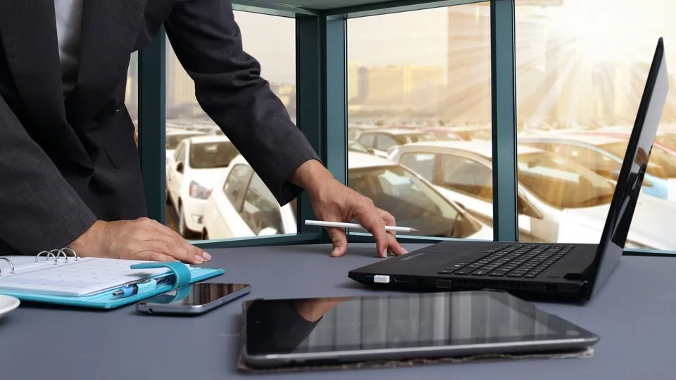 bussiness man working in office with  New Cars in Stock. Car Dealership Cars For Sale background